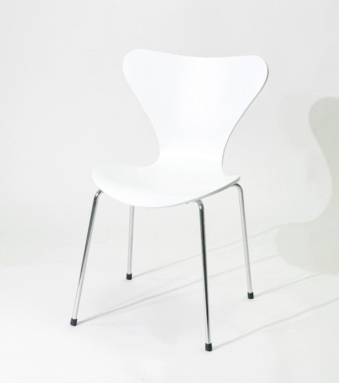 White modern dining chair with chrome legs, minimalist design for home or office use