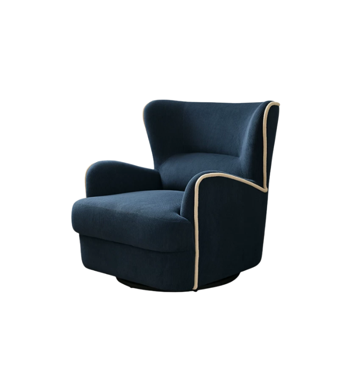 A navy blue velvet swivel armchair with cream-colored piping trim, shown from a three-quarter angle on a solid white background.