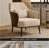 A modern accent chair with deep coffee-colored leather side panels and black metal legs, upholstered in a beige and brown tree-leaf patterned fabric. The image includes text overlays detailing the pattern, dimensions, and fabric features.