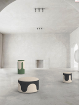 Round dual-tone upholstered drip fluid pouf with flowing design for breakout spaces