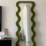 green fabric upholstered standing mirror