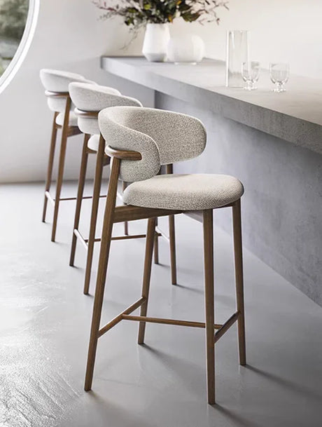 Contemporary bar chair with padded seat, curved backrest, and footrest