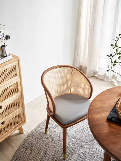 Elio cane dining armchair featuring handwoven rattan back, wooden frame and padded seat for modern dining spaces