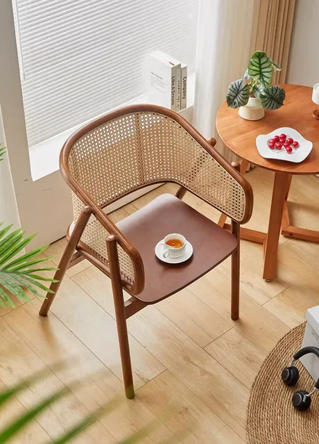 Modern cane armchair featuring a solid wood seat and natural rattan backrest, ideal for dining or lounge use