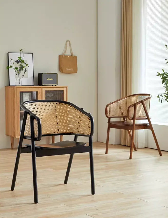 Black wood seat rattan armchair with natural cane back and sturdy wooden legs in minimalist interior