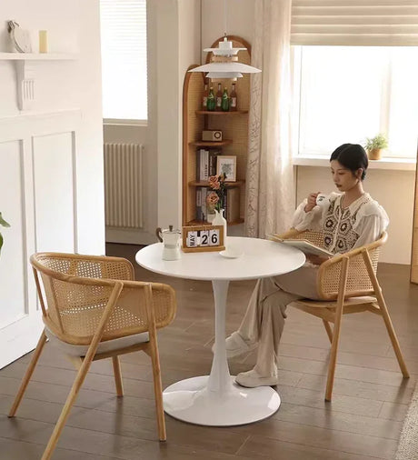 Riva rattan dining arm chair in natural wood color.