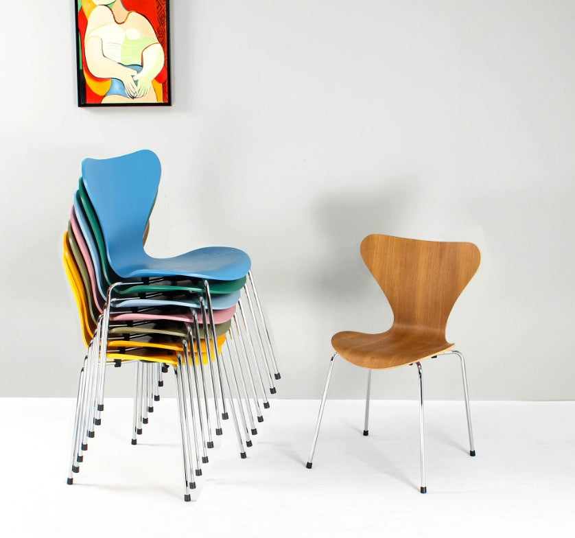 Stackable modern chairs in vibrant colors and wood finish, ideal for home or office use in Singapore