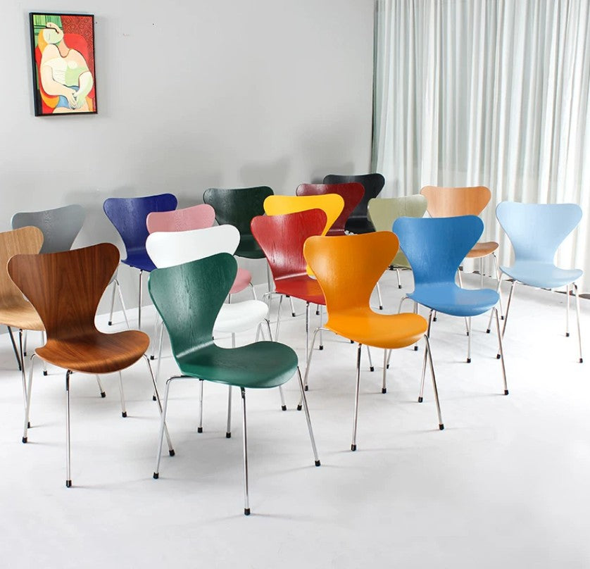Colorful modern dining chairs in various hues, ideal for home or office spaces with sleek metal legs.