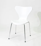 White modern dining chair with chrome legs, minimalist design for home or office use