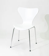 White modern dining chair with chrome legs, minimalist design for home or office use