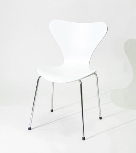 White modern dining chair with chrome legs, minimalist design for home or office use