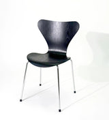 Modern black wood dining chair with chrome legs, sleek design for home or office use