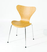 Modern wooden chair with chrome legs, sleek design for home or office use